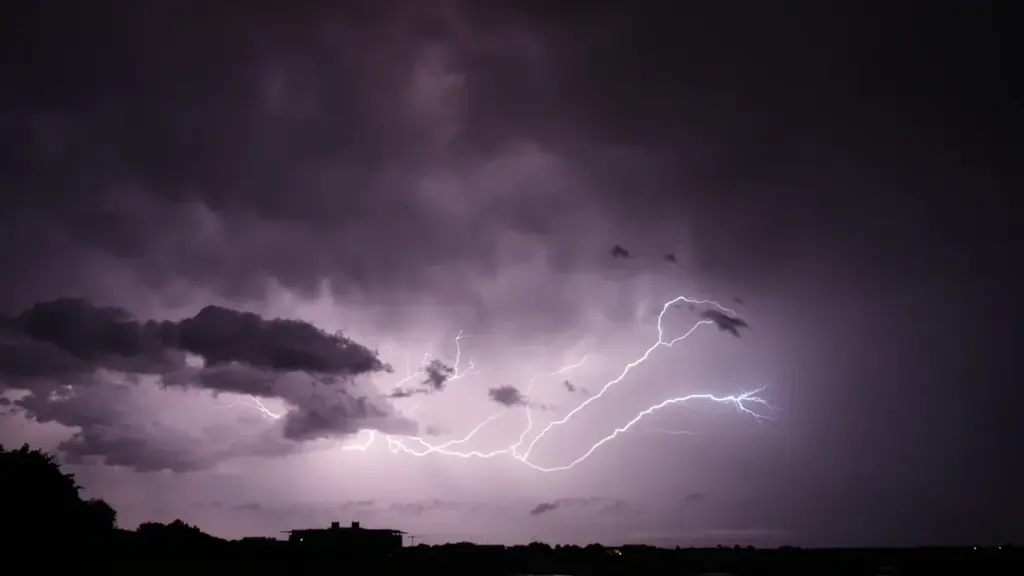 Orage impressionnant avec des éclairs frappant au-dessus d'un paysage urbain français.